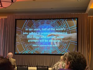 Presentation slide from Innovative User Group Conference, reading "In ten years, half of the world's jobs will be in prompt engineering. And those who cannot write prompts will be obsolete."